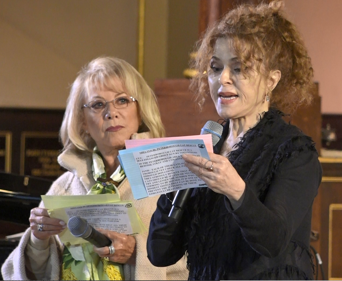 West End and Broadway legends respectively, Elaine Paige and Bernadette Peters stand on stage giving information on each dog that is showcased from animal shelters during West End Woofs