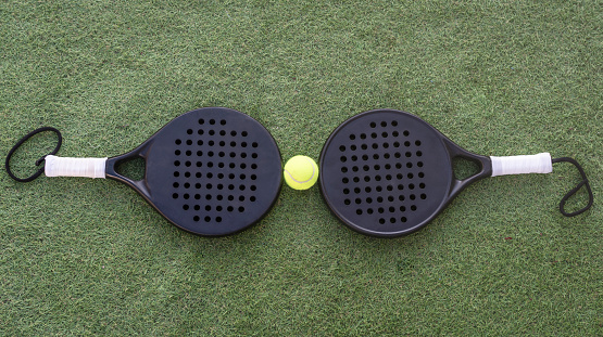 Two padel rackets and a ball