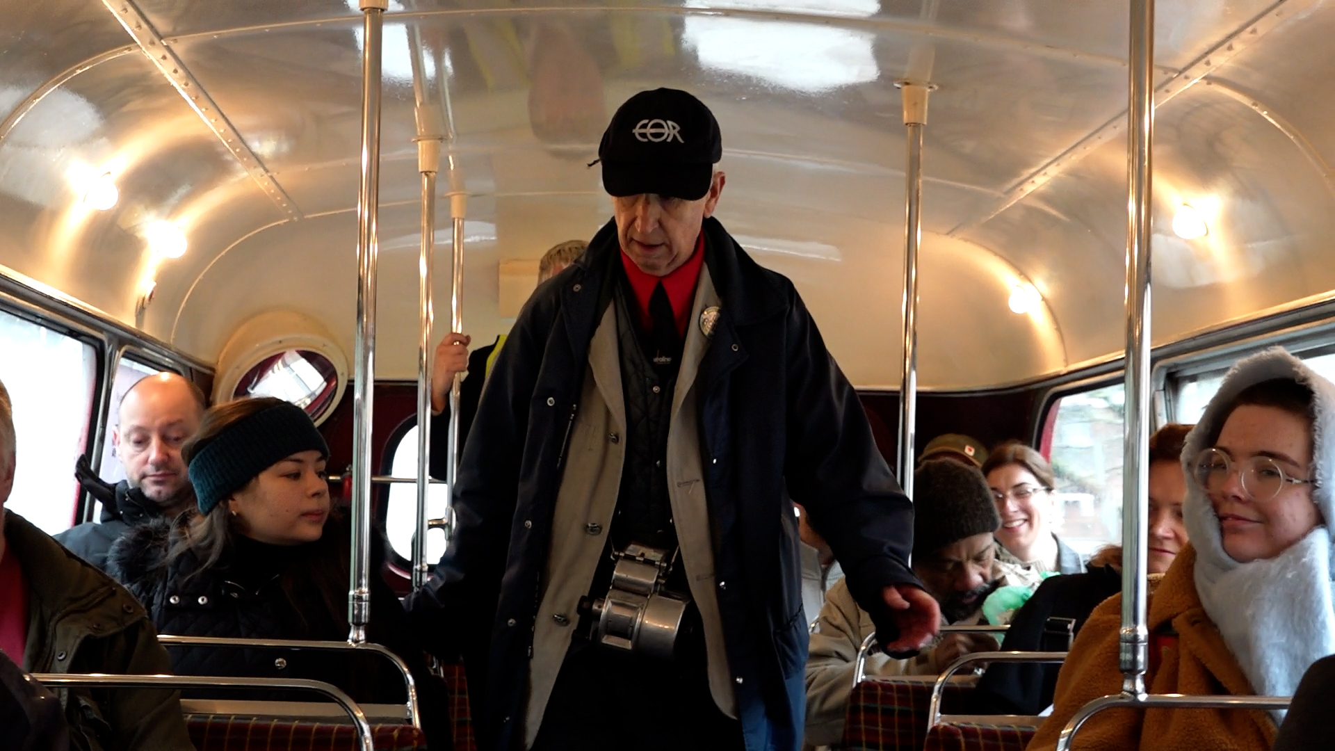 Man walking down bus collecting tickets