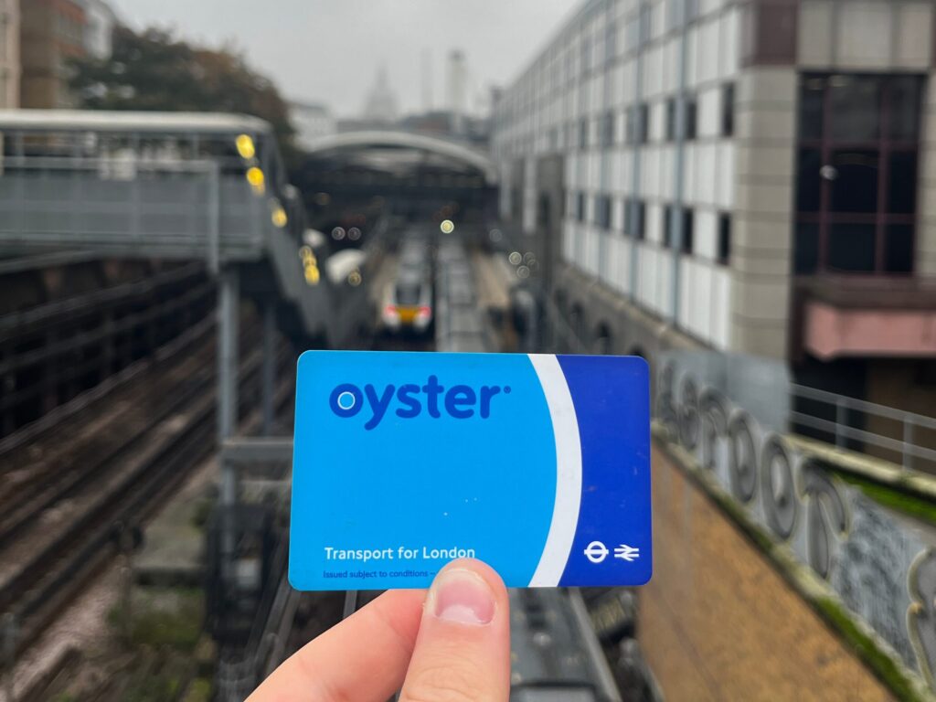 Oyster card held up outside Farringdon Station