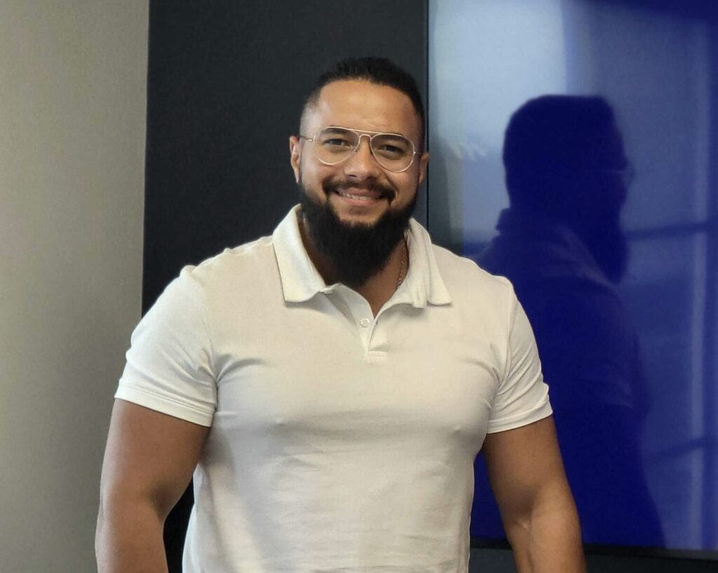 Mr. Sami Eltamawy, Head of Cybersecurity and IT at Stenn Technologies. Interviewee. White shirt, beard, blue wall in the background, white wall in the background. Shadow in the background