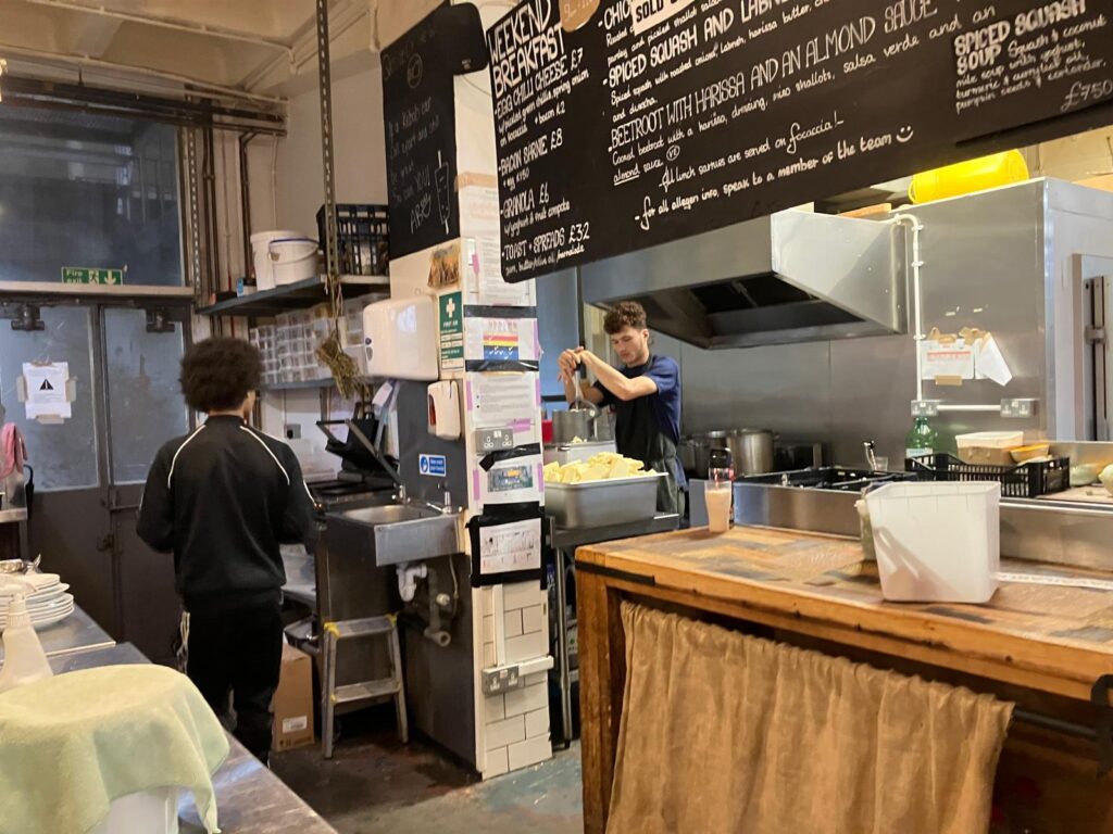 Two men working in the kitchen of the Dusty Knuckles bakery