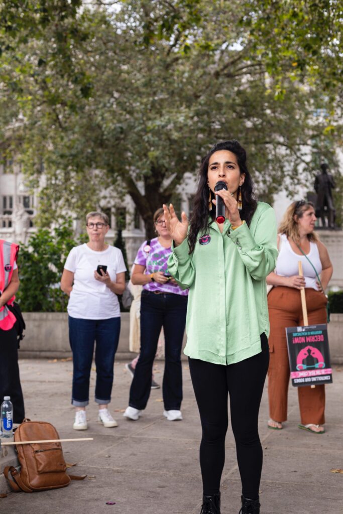 Sonia Adesara, NHS doctor and campaigner for women's reproductive rights, stood speaking into a microphone.