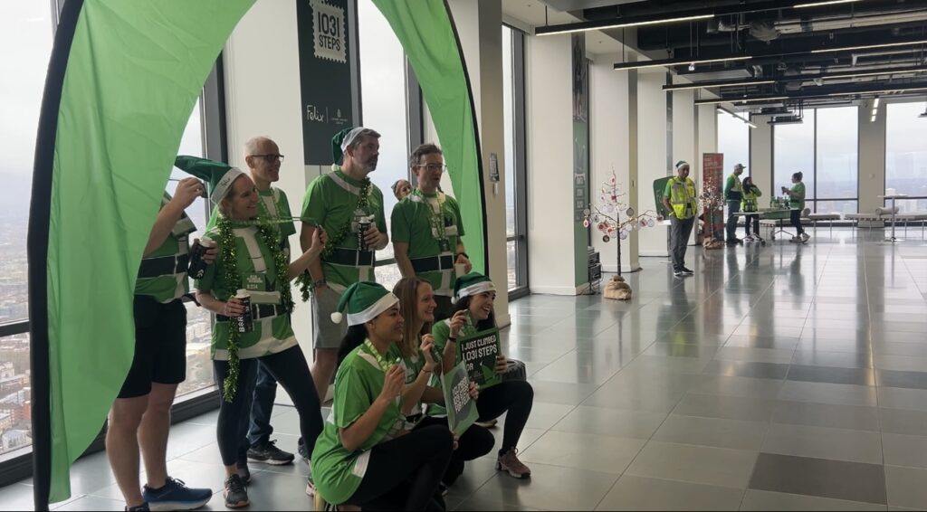 Volunteers celebrating with their medals after completing the stair climb. 