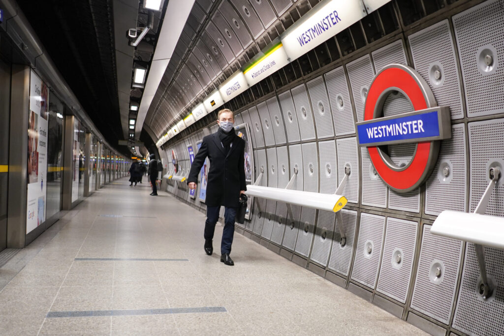 A person walking in Westminster Underground station.