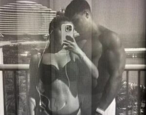 Molly-Mae and Tommy Fury taking a picture together in swimwear