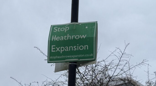 A campaign sign reading 'Stop Heathrow Expansion'.