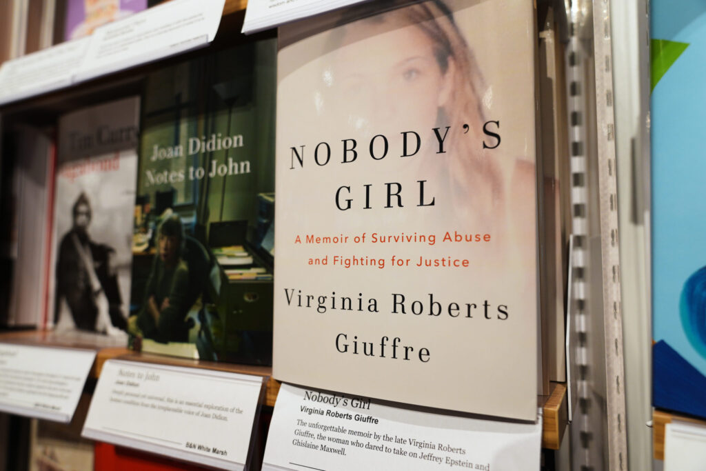 A copy of "Nobody's Girl: A Memoir of Surviving Abuse and Fighting for Justice" by Virginia Roberts Giuffre displayed on a shelf at a Barnes & Noble Booksellers
