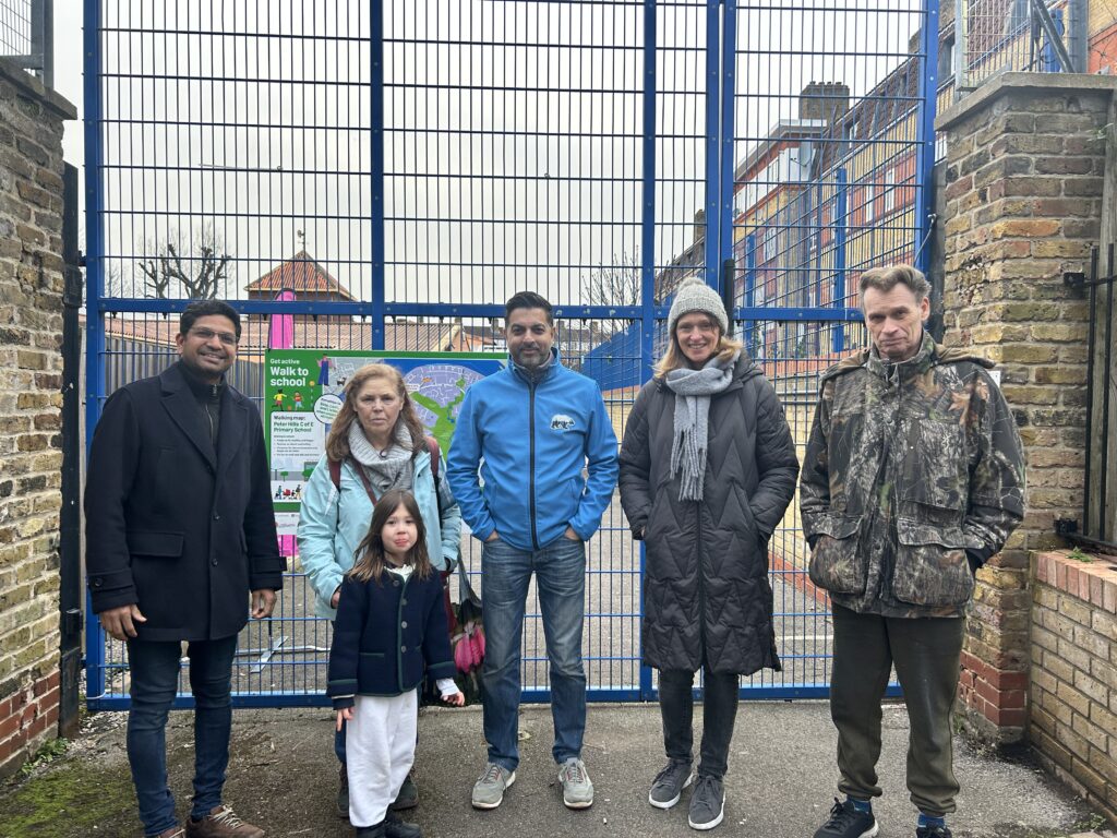 Volunteers for the Rotherhithe Community Kitchen stand at the gates of Peter Hill's Primary School