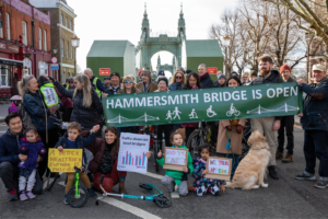 Protestors for the 'Hammersmith Bridge is Open' campaign hold up placards at a January protest.