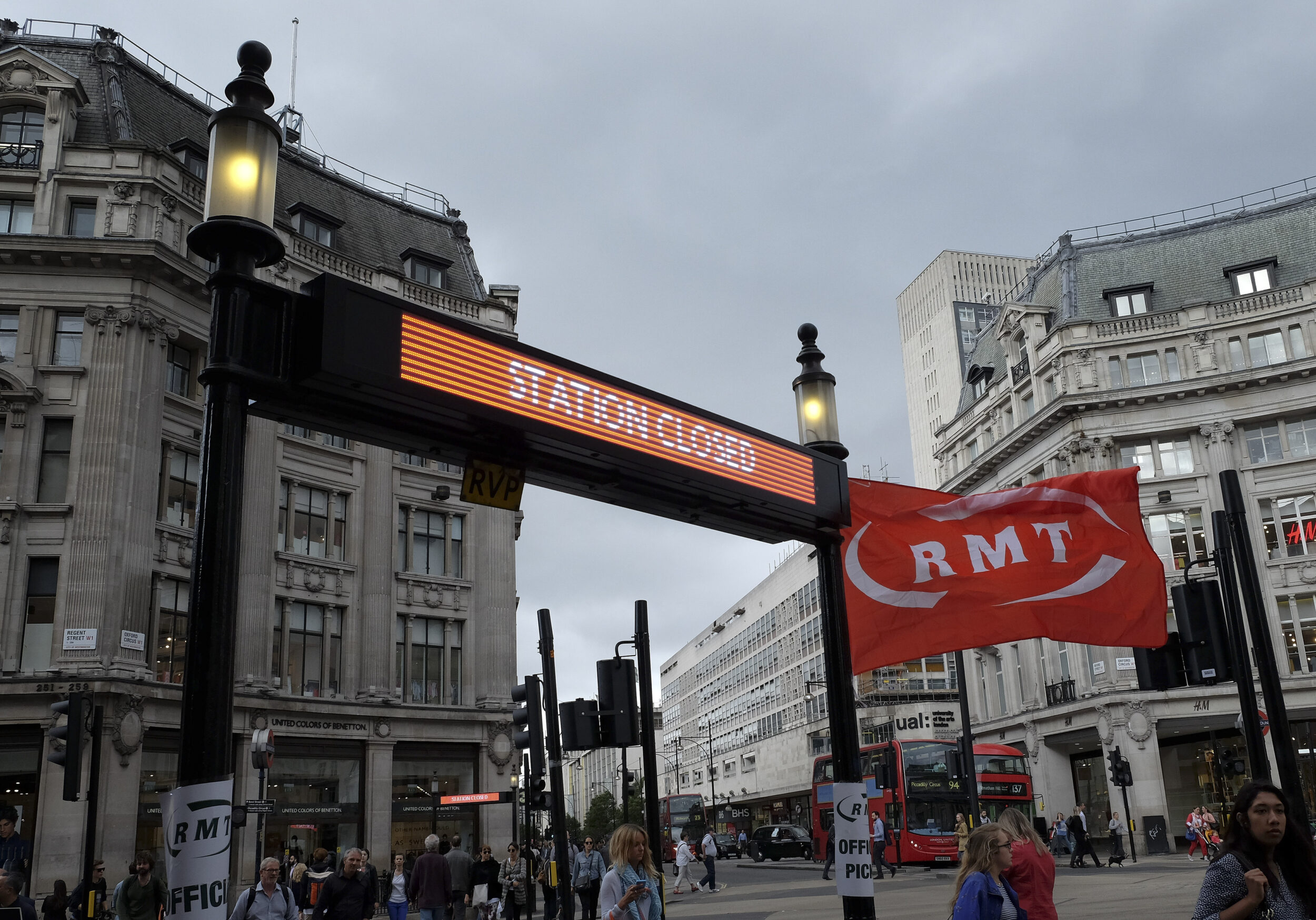 A sign shows a station closed next to an RMT union flag.